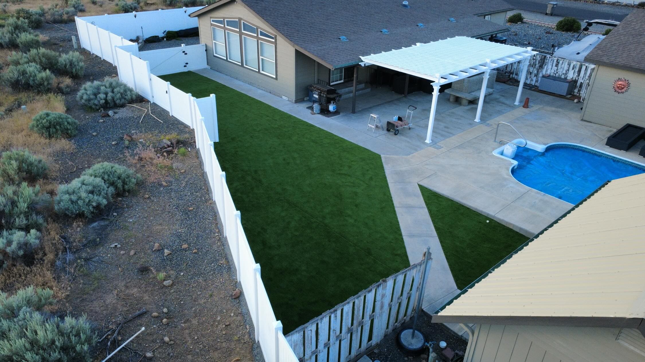 Completed artificial turf backyard with vinyl privacy fence